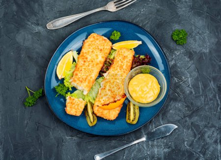 Photo for Fish fillet roasted in bread crumbs and with kiwi. Top view. - Royalty Free Image