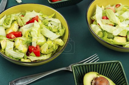 Téléchargez les photos : Salat vert frais de laitue, concombres, tomate et avocat. Une saine alimentation. Végétarien. - en image libre de droit