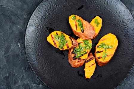 Photo for Grilled sweet potato, batata with olive oil and herbs. Copy space. - Royalty Free Image