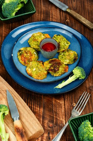 Fried vegetable cutlets with white sauce. Vegan broccoli cutlets on a wooden table. Cabbage cutlets.