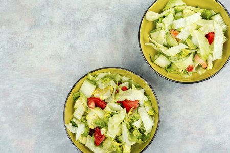 Photo for Vegetable salad of cabbage, avocado, cucumber and tomato. Copy space for text. - Royalty Free Image