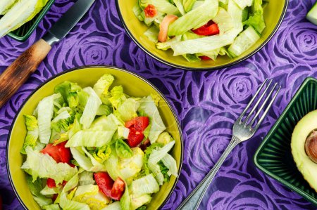 Photo for Healthy salad bowl with different lettuce, avocado, cucumber and tomato. - Royalty Free Image