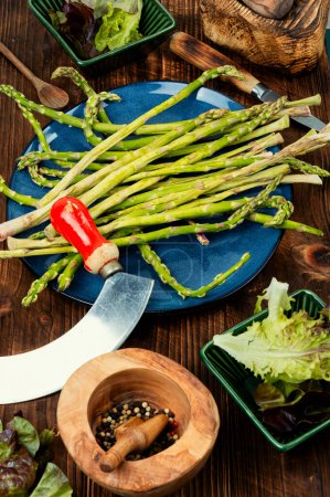 Photo for Green raw and fresh asparagus on rustic wooden table. - Royalty Free Image