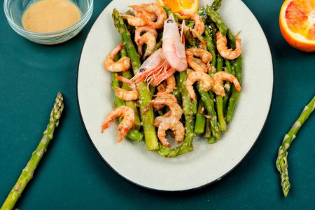 Seasonal salad with prawns, green asparagus. Boiled shrimp with green asparagus.