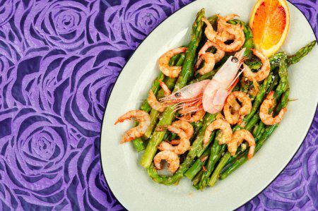 Delicious boiled shrimp with green asparagus. Ready to eat. Home cooking. Space for text.