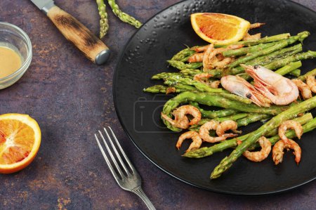 Delicious boiled shrimp with green asparagus spears.