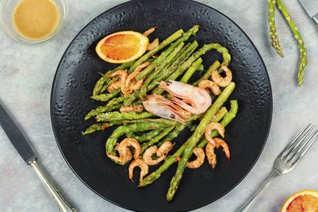 Delicious boiled shrimp with green asparagus. Seafood menu.