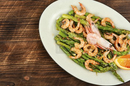 Delicious boiled shrimp with green asparagus. Ready to eat. Space for text.