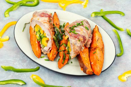 Photo for Roulade or meat roll, stuffed with peppers and baked sweet potatoes, batata. Roasted pork ham. - Royalty Free Image