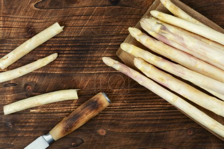 Raw white asparagus on an old rustic wooden. Fresh and natural uncooked asparagus.