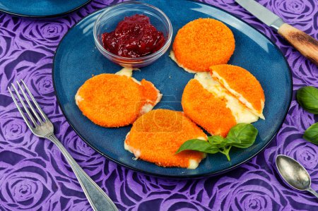 Photo for Baked or fried camembert cheese with berry sauce on a plate. - Royalty Free Image
