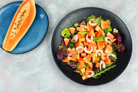 Photo for Delicious salad with sweet papaya, shrimp prawns and fresh green lettuce. Top view. - Royalty Free Image