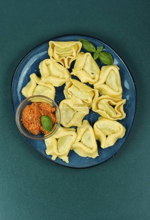 Tortellini, or filled dumplings. Italian traditional tortellini pasta or ravioli. Flat lay.