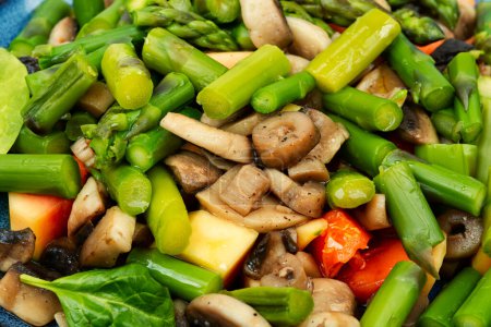 Photo for Dietary vegetarian salad of green asparagus and fried mushrooms. Healthy salad. Close up. - Royalty Free Image