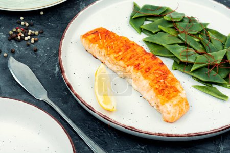 Photo for Grilled salmon fillets steaks with a green beans. - Royalty Free Image