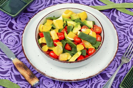 Homemade vegetable salad with bell pepper, tomato, avocado and runner beans or green bean.