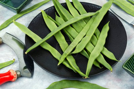 Photo for Fresh raw green beans and a grass knife. Green Romano beans - Royalty Free Image
