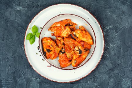 Photo for Grilled, baked spicy chicken wings on a plate. Top view, flat lay. Copy space. - Royalty Free Image