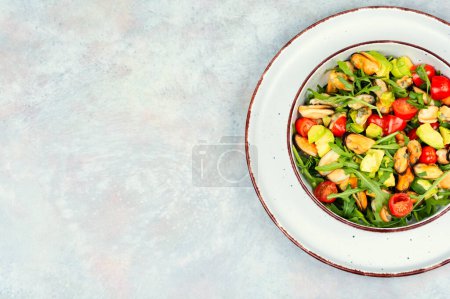 Photo for Plate with vitamin salad of mussels, arugula, tomato and avocado. Space for text. - Royalty Free Image