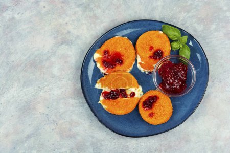 Photo for Baked or fried Camembert cheese with cranberry sauce. Copy space. - Royalty Free Image