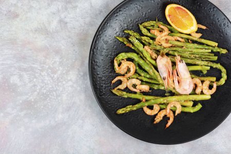 Seasonal salad with prawns, green asparagus. Flat lay with copy space.