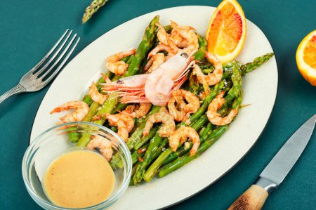 Photo for Delicious roasted shrimp with green asparagus. Seafood menu. - Royalty Free Image