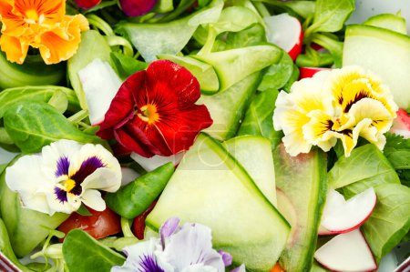Pansy fresh salad of vegetables, edible flowers, field pansies, violets. Detox food, close up.