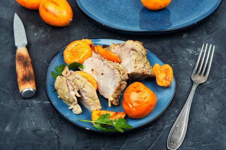 Photo for Roasted pork tenderloin or meat baked with fruits marinade. Meat roasted with medlar fruit - Royalty Free Image