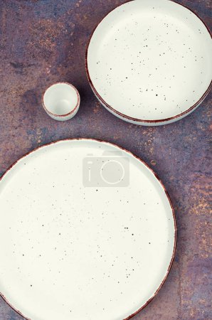 Photo for Empty ceramic plates on the table. Card or menu template. Tableware, crockery. Top view. - Royalty Free Image