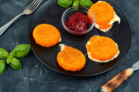 Photo for Baked or fried Camembert cheese with berry sauce or jam. - Royalty Free Image