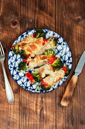 Photo for Delicious roll of meat or roulade with broccoli and bell pepper on rustic wooden table. - Royalty Free Image