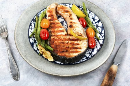 Photo for Fried salmon steak and grilled potatoes and green beans. Grilled fish. - Royalty Free Image