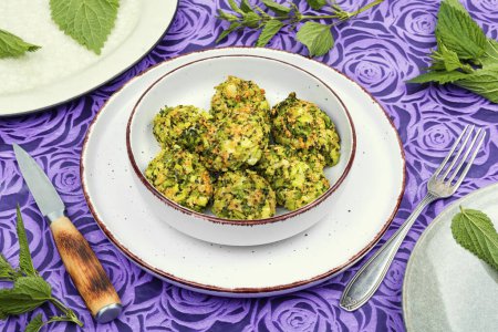 Photo for Plate with green dietary cutlets of young nettles. Vegetarian pancakes with broccoli and nettles - Royalty Free Image