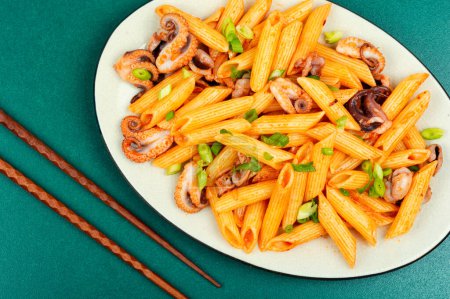 Photo for Appetizing macaroni or pasta with tentacles of octopus. Pasta with seafood. - Royalty Free Image