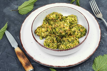 Photo for Delicious green dietary cutlets of stinging nettles leaves on concrete background. Vegan food no meat. - Royalty Free Image