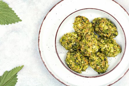 Baked green dietary cutlets made from young nettles. Vegetarian food. Space for text.