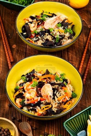 Photo for Thailand cuisine dish with rice, shrimps and vegetables on a vintage wooden background. Asian food style. - Royalty Free Image