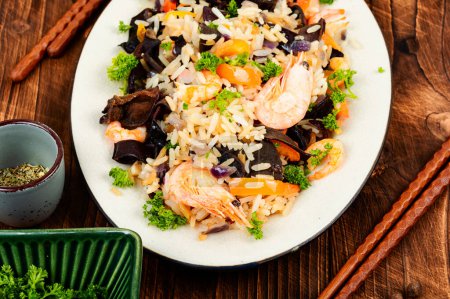 Photo for Traditional Chinese food, fried rice with shrimp and mushrooms. - Royalty Free Image