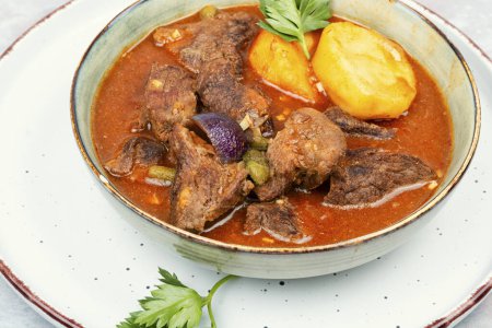Appetizing goulash made from venison meat, meat goulash or soup with potatoes in a bowl.