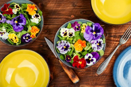 Photo for Seasonal pansy edible flower salad on a rural table. Healthy eating - Royalty Free Image