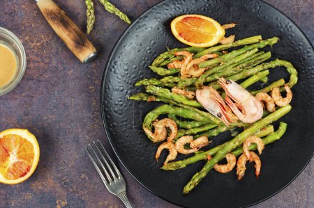 Delicious boiled shrimp with green asparagus. Clean eating. Ready to eat.