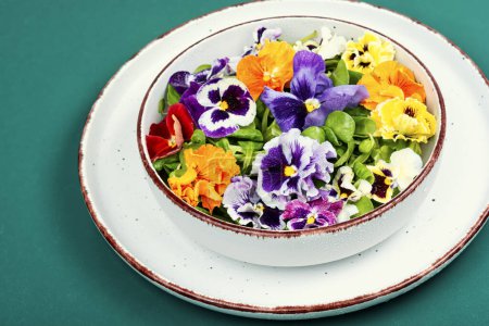 Edible flower salad in a bowl. Fresh salad with flowers.