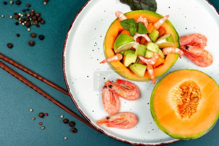 Salad, fruit salad of shrimp, melon and avocado in melon. Balanced, clean diet food. Copy space.