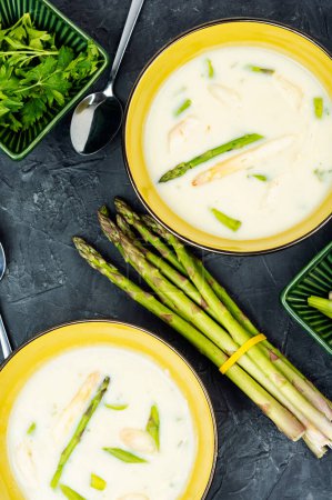 Dietary vegetarian soup puree with white and green asparagus. Top view