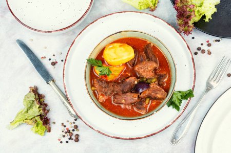 Appetizing goulash made from venison meat, meat goulash with potatoes in a bowl.