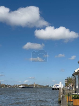 Photo for Inland barge freight shipping transport sailing past Dordrecht in Holland in the Netherlands on the calm river water of the Maas. Container ship transporting goods. - Royalty Free Image