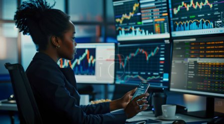 In this compelling image, a black woman confidently navigates the complexities of the stock market, surrounded by a high-tech office environment. With her smartphone in hand, she seamlessly integrates technology into her trading strategy, while multi