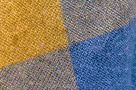 detail of colored wool fabric worn by use with some specks on it, fabric texture