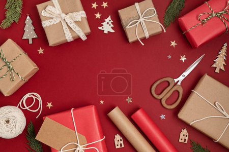 Photo for Christmas background with gift boxes and rolls of colored kraft wrapping paper. Xmas celebration, preparation for winter holidays. Festive mockup, top view, flatlay - Royalty Free Image