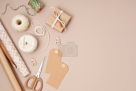 Photo for Christmas background with gift boxes and rolls of colored kraft wrapping paper. Xmas celebration, preparation for winter holidays. Festive mockup, top view, flatlay - Royalty Free Image